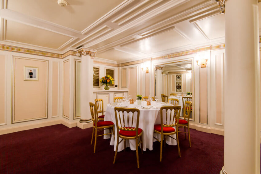 The Royal Retiring Room at the London Coliseum - Grand ornate room with white walls set for private dinner