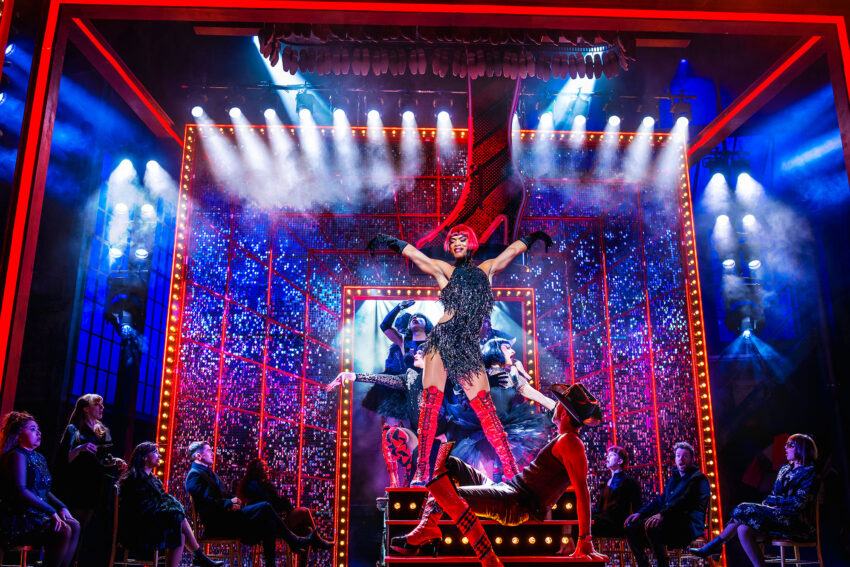 Johannes Radebe as Lola with the cast in Kinky Boots at the London Coliseum