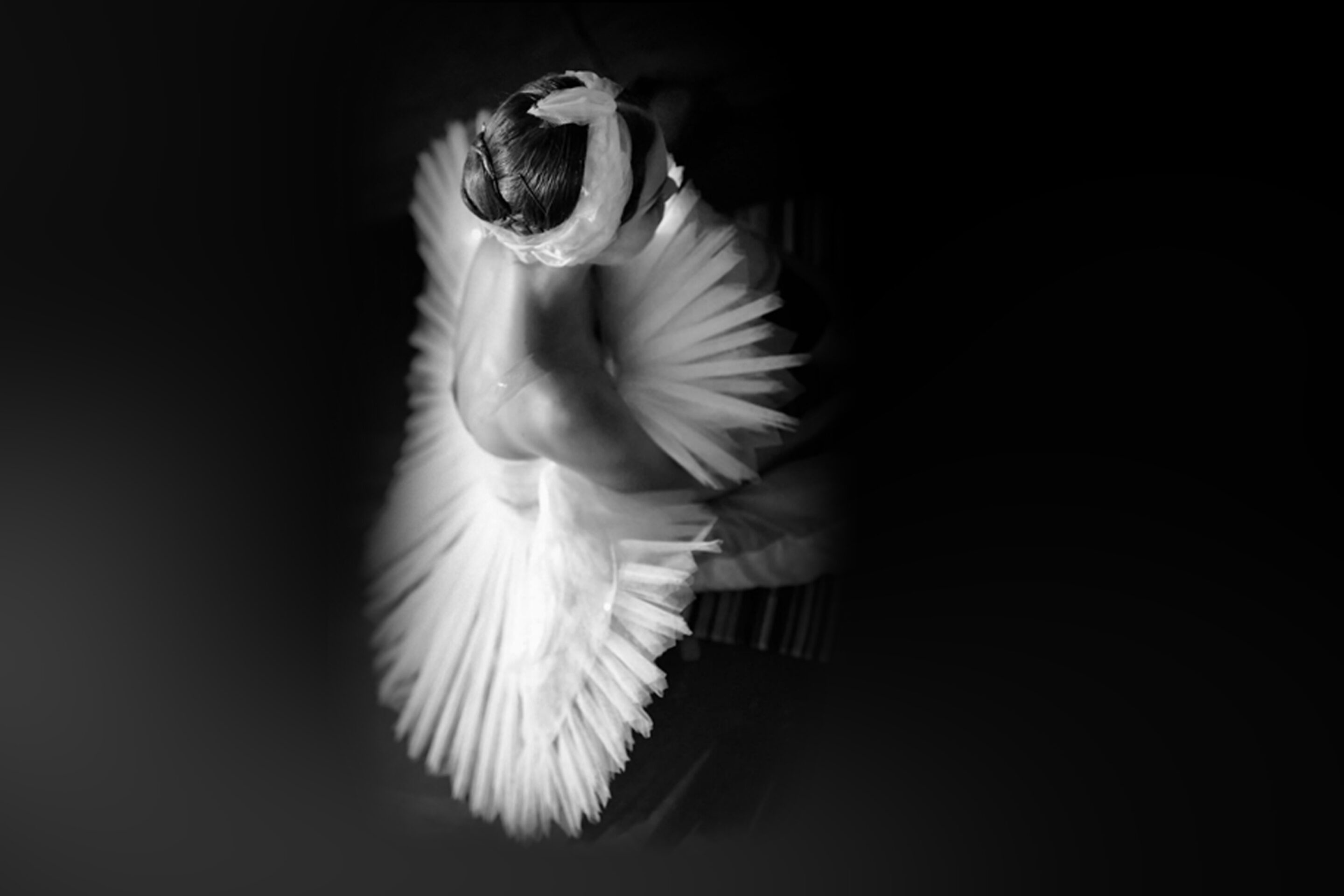 Black and white overhead image of a ballet dancer